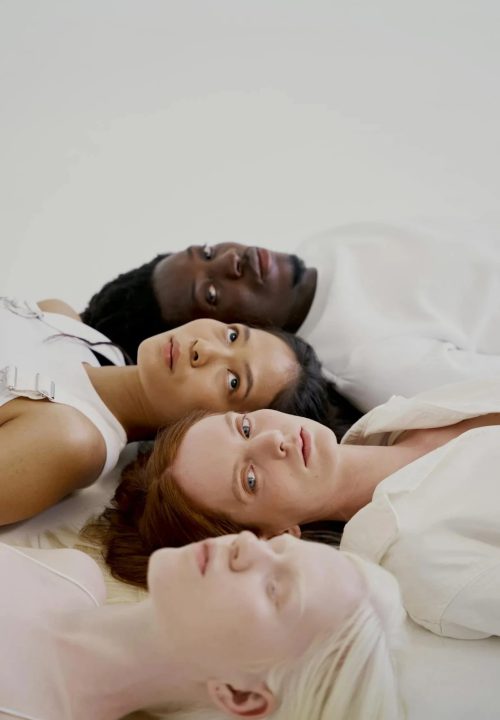 women-and-man-lying-on-white-surface-10211662